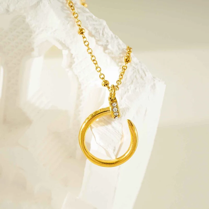 CSENGE Gold Necklace: Zirconia Embedded Circular Nail Pendant on a Satellite Beaded Chain